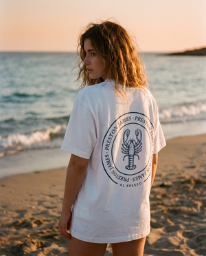Lobster Stamp tee worn at golden hour on a Mediterranean beach