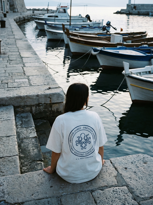 Octopus Stamp tee worn at a Mediterranean harbor at dawn