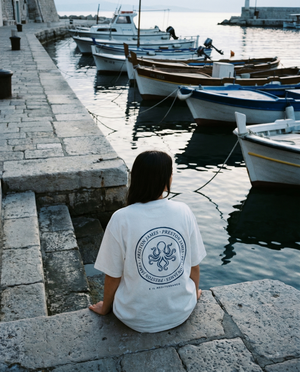 Octopus Stamp tee worn at a Mediterranean harbor at dawn