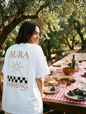 Aura Farming tee at a long Mediterranean lunch