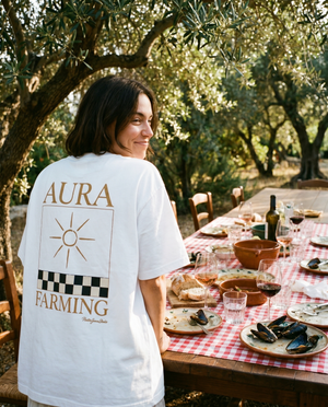 Aura Farming tee at a long Mediterranean lunch